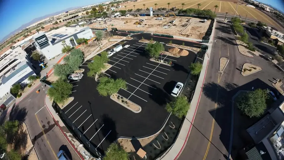 Aerial of completed asphalt parking lot and site paving